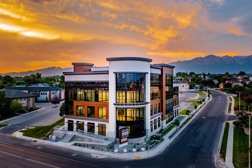 Vero Dental Lehi Utah dentist office building with mountain sunset